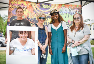 A smiling group of HopeWorks staff members standing together at an event.