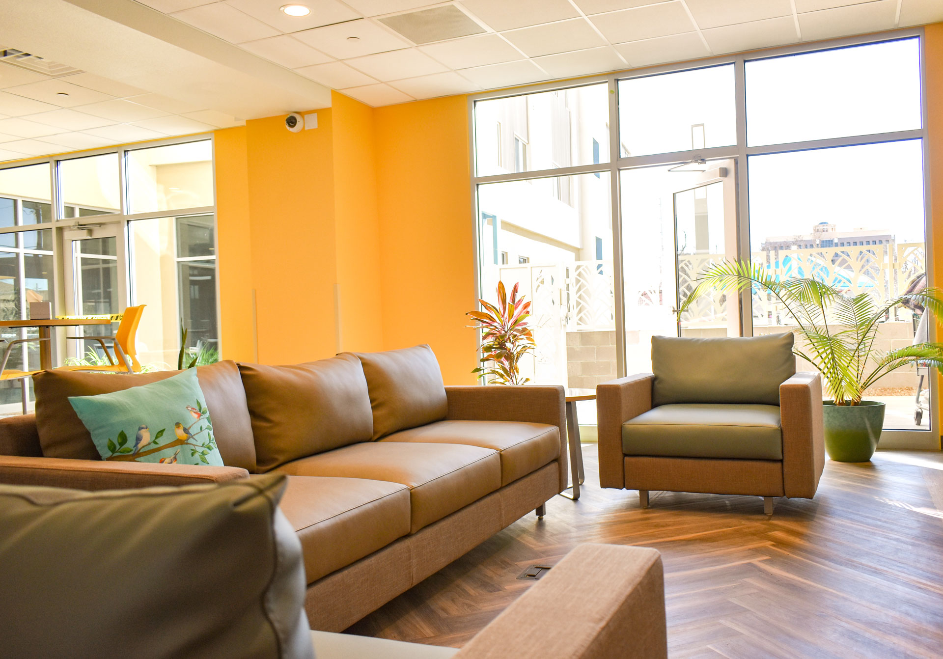 Seating area in the Psycho-Social Rehabilitation program area at Hope Village. Bright yellow walls.